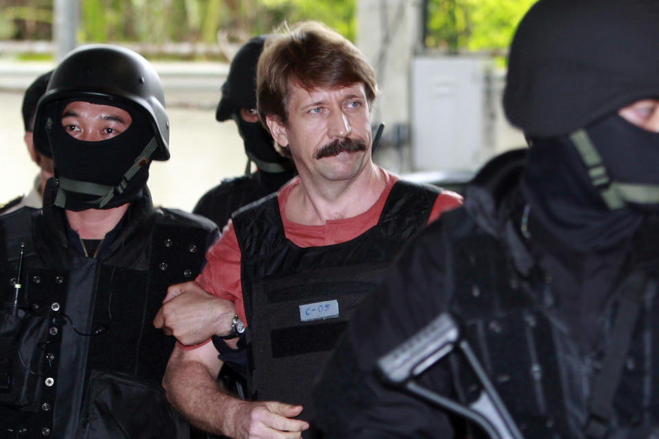 FILE - Suspected Russian arms smuggler Viktor Bout, center, is led by armed Thai police commandos as he arrives at the criminal court in Bangkok, Thailand in Oct. 5, 2010. Russia has freed WNBA star Brittney Griner on Thursday in a dramatic high-level prisoner exchange, with the U.S. releasing notorious Russian arms dealer Viktor Bout. (AP Photo/Apichart Weerawong, File)