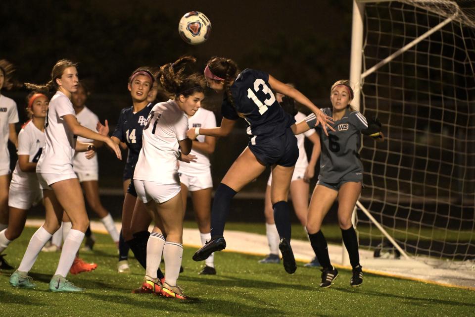 Boca Raton mid-fielder Sarah Coelho (13) does a header in front of the West Boca goal to attempt to set up a score on Dec. 15, 2023.
