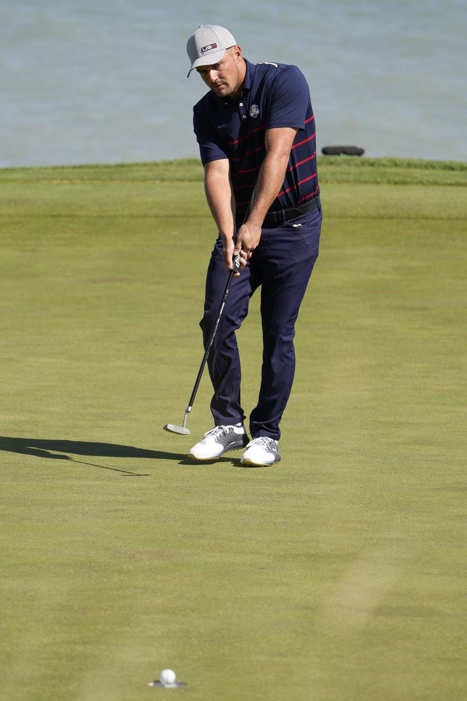 Team USA's Bryson DeChambeau makes a putt during a four-ball match the Ryder Cup at the Whistling Straits Golf Course Friday, Sept. 24, 2021, in Sheboygan, Wis. (AP Photo/Jeff Roberson)