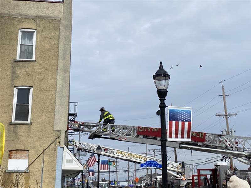 A firefighter battling a fire in apartments above Bain's Hardware on Ocean Avenue in Sea Bright on Friday, March 10, 2023