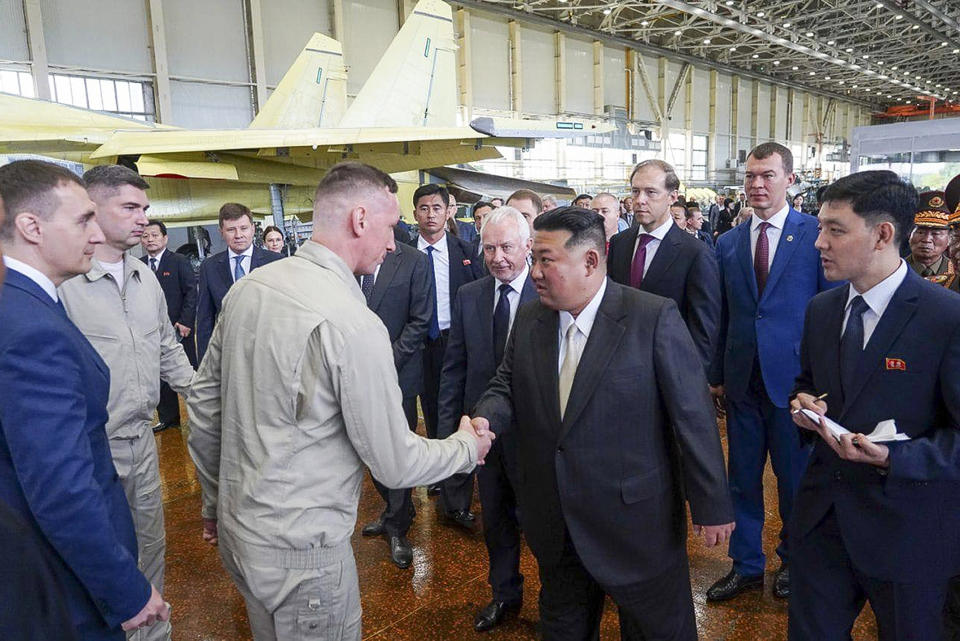 ADDS DATE - In this photo released by the governor of the Russian far eastern region of Khabarovsky Krai region Mikhail Degtyarev telegram channel, North Korean leader Kim Jong Un, center, shakes hands with employees while visiting a Russian aircraft plant that builds fighter jets in Komsomolsk-on-Amur, about 6,200 kilometers (3,900 miles) east of Moscow, Russia, Friday, Sept. 15, 2023. (The governor of the Russian far eastern region of Khabarovsky Krai region Mikhail Degtyarev telegram channel via AP)