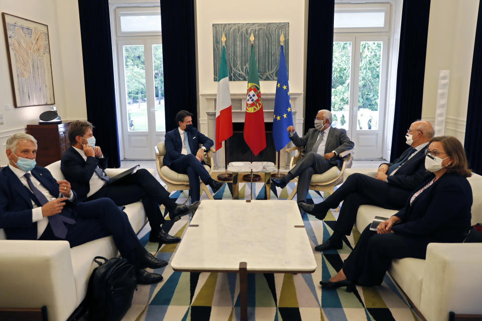 Italy's Prime Minister Giuseppe Conte, centre left is received by Portugal's Prime Minister Antonio Costa, center right, at the Sao Bento palace in Lisbon, Tuesday, July 7, 2020. Southern European countries are mounting a show of strength as negotiations over how much money they get from the EU, and in what form, comes to a crunch. (AP Photo/Armando Franca)