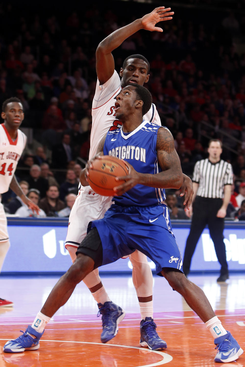 Creighton's Devin Brooks, front, is fouled on his way to the basket by St. John's Rysheed Jordan during the first half of an NCAA college basketball game, Sunday, Feb. 9, 2014, in New York. (AP Photo/Jason DeCrow)