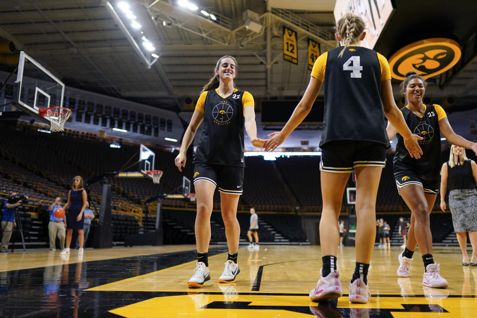 Iowa guard Caitlin Clark reacts with teammate Kylie Feuerbach (4) during practice following an NCAA college basketball media day, Wednesday, Oct. 4, 2023, in Iowa City, Iowa. (AP Photo/Charlie Neibergall)