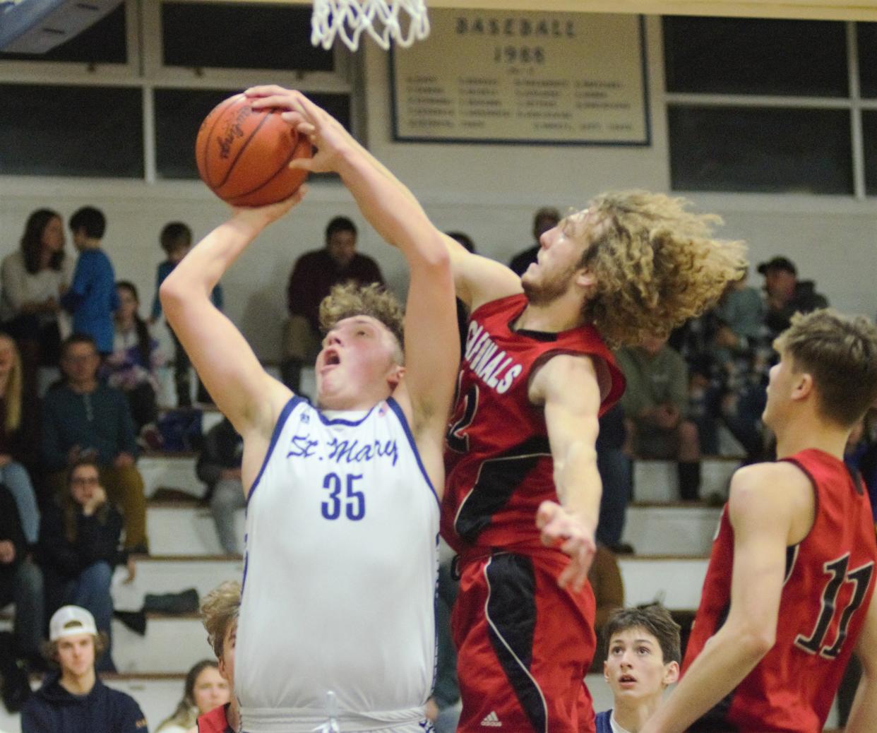 Thomas Fox blocks Lucas Cherwinski's shot during a boys basketball matchup between Gaylord St. Mary and Johannesburg-Lewiston on Thursday, Jan. 18.