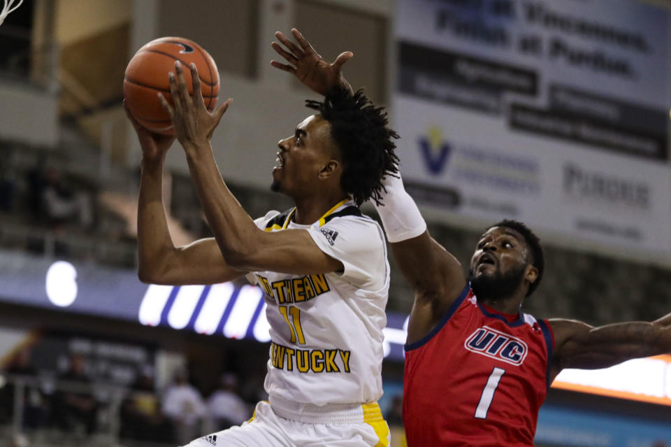 Northern Kentucky guard Jalen Tate (11) shoots in front of Northern Kentucky guard Adham Eleeda (1) during the first half of an NCAA college basketball game for the Horizon League men's tournament championship in Indianapolis, Tuesday, March 10, 2020. (AP Photo/Michael Conroy)