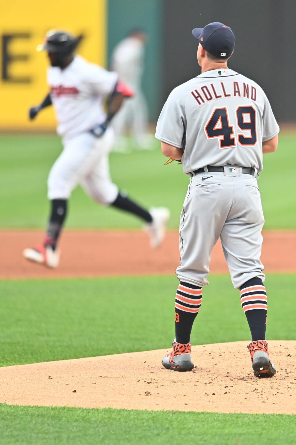 Cleveland designated hitter Franmil Reyes rounds the bases after hitting a home run as Tigers pitcher Derek Holland stands on the mound during the first inning on Friday, April 9, 2021, in Cleveland.