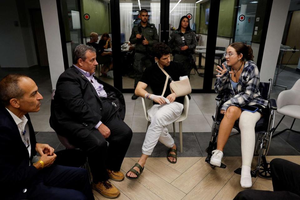 PHOTO: Former NJ Governor Chris Christie talks with Yadin, a soldier, and Sheerel Gabay, survivor of the Nova Festival, that were injured in the Oct. 7 deadly attack at Sourasky Medical Center in Tel Aviv, Israel Nov. 12, 2023. (Amir Cohen/Reuters)