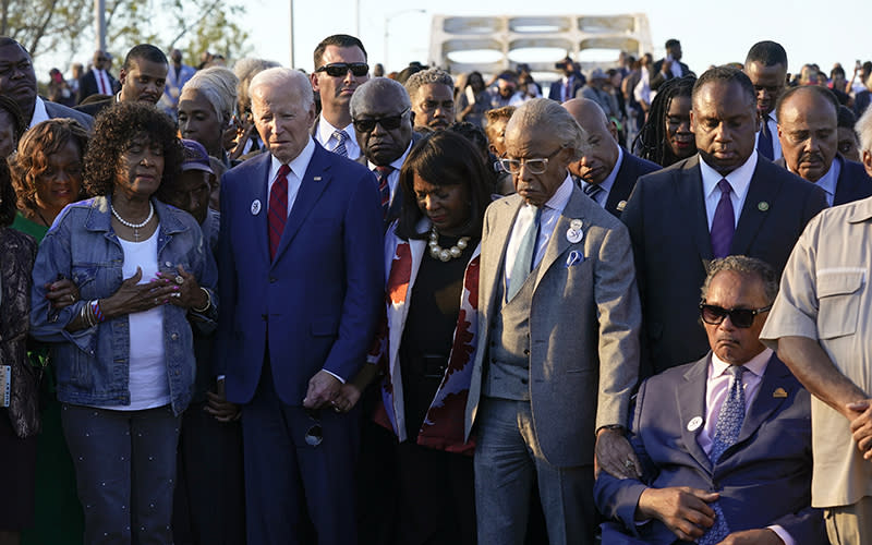 President Biden listens during a prayer after walking across the Edmund Pettus Bridge in Selma, Ala.