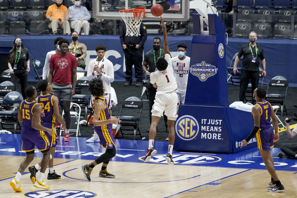 Alabama's Herbert Jones (1) scores the go-ahead layup in the final seconds to give Alabama the win over LSU in the championship game at the NCAA college basketball Southeastern Conference Tournament Sunday, March 14, 2021, in Nashville, Tenn. Alabama won 80-79. (AP Photo/Mark Humphrey)