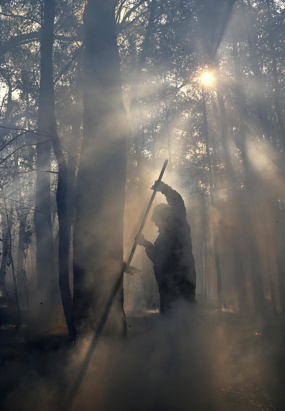 Firefighters mop up after a firestorm swept through a property in Bilpin, 75 kilometers (47 miles) from Sydney, Wednesday, Oct. 23, 2013. (AP Photo/Rob Griffith)