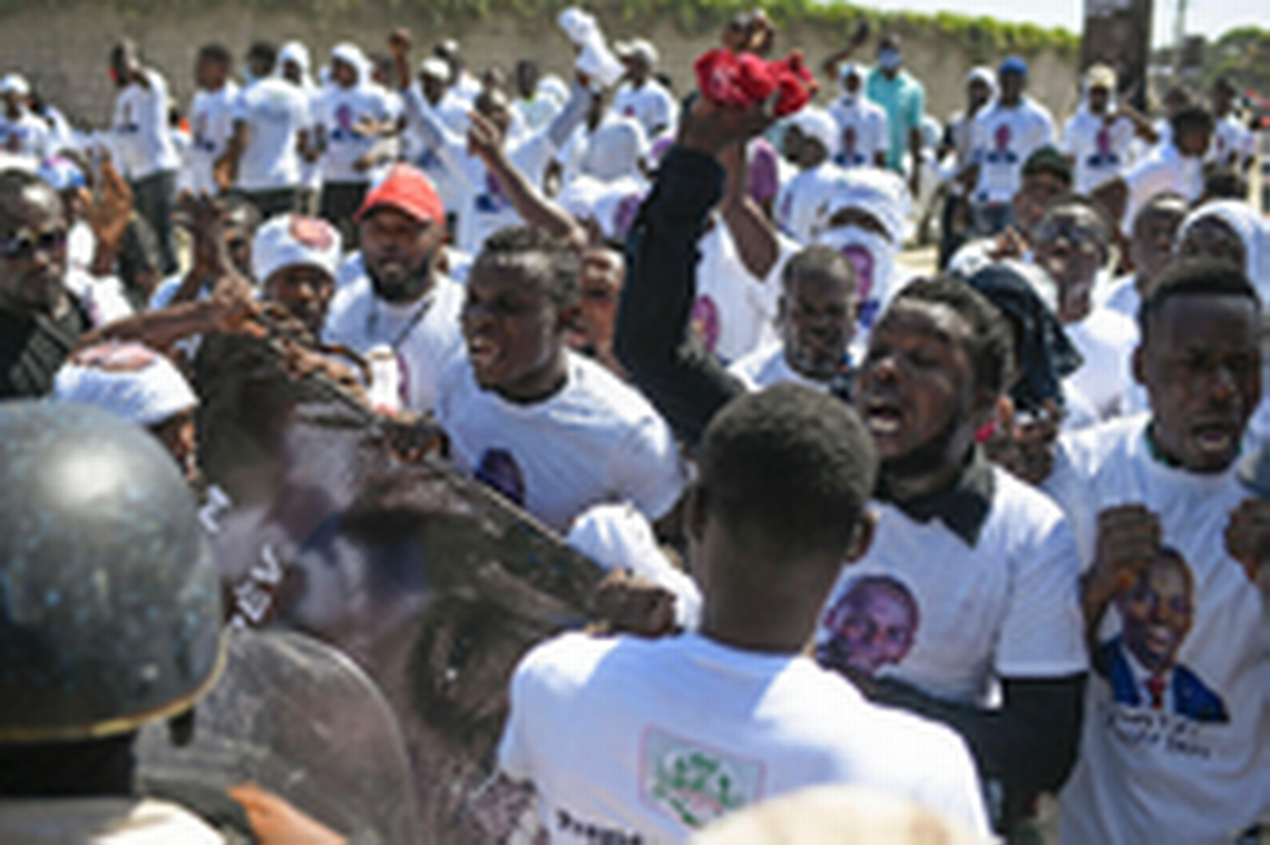 Supporters of slain Haitian President Jovenel Moïse are blocked from attending Moïse’s funeral outside his family home as they call for justice in Cap-Haïtien, Haiti, on Friday, July 23, 2021.