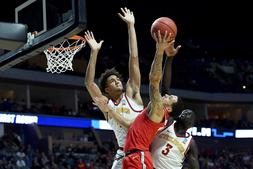 <p>George Conditt IV #4 and Marial Shayok #3 of the Iowa State Cyclones block Duane Washington Jr. #4 of the Ohio State Buckeyes during the first half in the first round game of the 2019 NCAA Men’s Basketball Tournament at BOK Center on March 22, 2019 in Tulsa, Oklahoma. (Photo by Stacy Revere/Getty Images) </p>