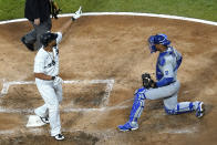 Chicago White Sox's Jose Abreu, left, celebrates after hitting a solo home run as Kansas City Royals catcher Salvador Perez looks to the field during the fourth inning of a baseball game in Chicago, Saturday, May 15, 2021. (AP Photo/Nam Y. Huh)