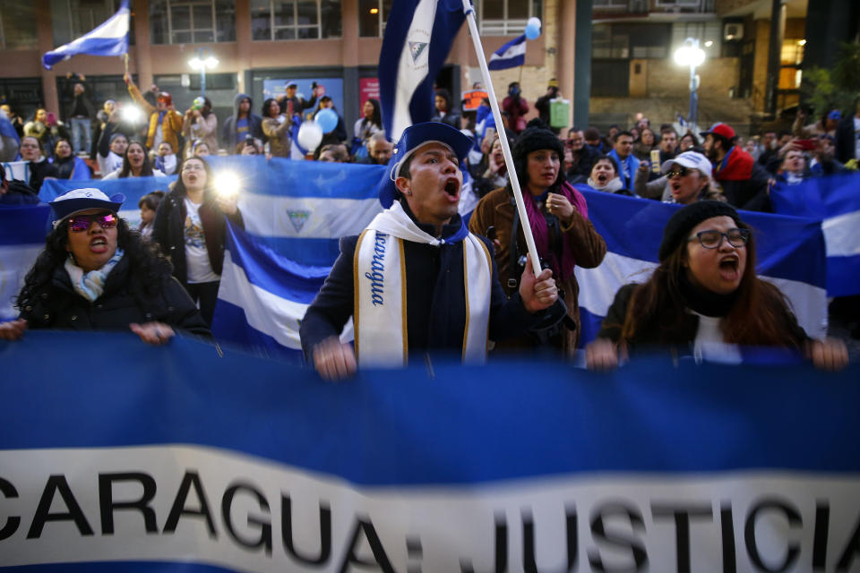 FILE - In this Jan. 12, 2019 file photo, demonstrators chant during a protest against the Nicaraguan government, in Madrid, Spain. A group of independent international experts sent by the Inter-American Commission on Human Rights to investigate violations wrote in its December report that the killings were carried out by the Nicaraguan police and pro-government gangs unleashed against the protesters. (AP Photo/Andrea Comas, File)