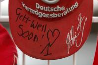 A cap marking the 45th birthday of seven-times former Formula One world champion Michael Schumacher is placed on a fence outside Schumacher's cart racing track in the western city of Kerpen January 3, 2014. REUTERS/Ina Fassbender