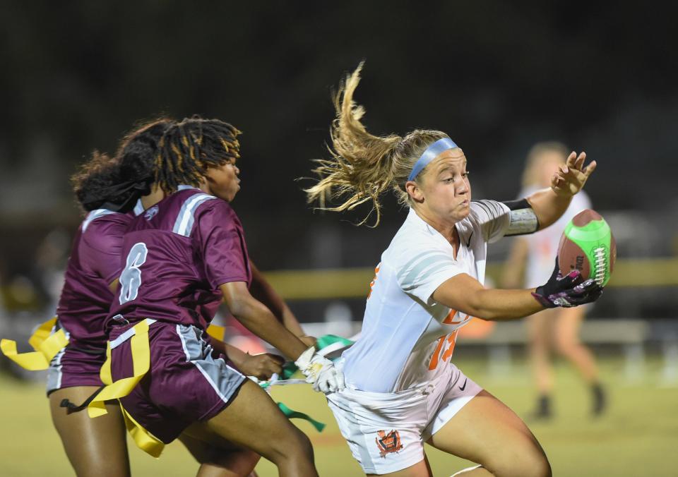 Lahela Cornett (19) of St. Lucie West Centennial, comes close to the goal line before losing her flags to Fort Pierce Westwood's Gerriyah Ruth (6) and Daynicha Celisca (11 left background) during the Flag Football Autism Acceptance Invitational Tournament at the South County Stadium on Friday in Port St. Lucie.