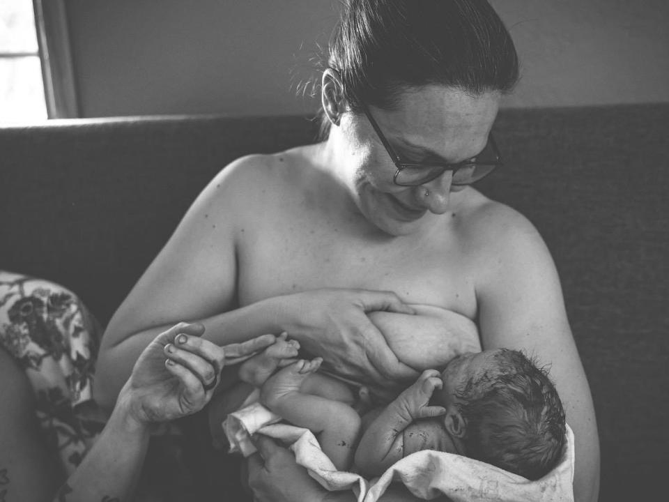 Jackie Kent, a new mother, breastfeeds her daughter Sutton, to whom she did not give birth.