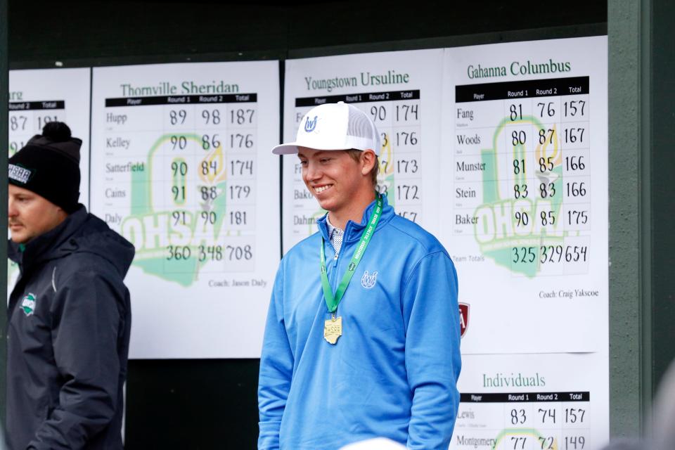 Wyoming junior Finley Bartlett celebrates with his medal after winning the Division II individual state championship Saturday at NorthStar Golf Club in Sunbury, Ohio. Bartlett, who had the top qualifying district score among all 72 players, posted a two-day total of 146 to win by two shots. The Cowboys finished runner-up behind champion Kettering Alter.
