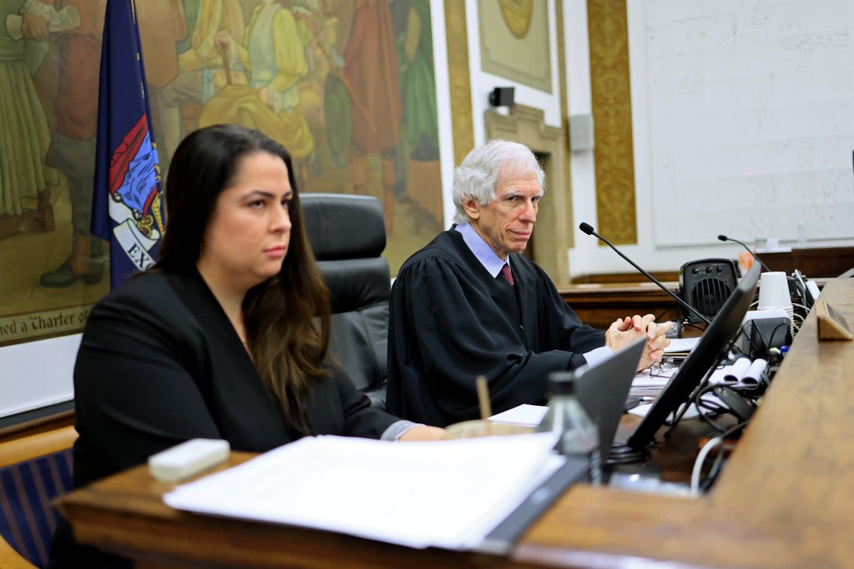 Justice Arthur Engoron, right, presides over Donald Trump’s civil fraud trial on 13 November, with his chief clerk Allison Greenfield beside him. (Getty Images)