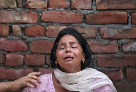 Kiran Bala, wife of Amarjit Kumar, a shopkeeper who was killed in a gunfight, weeps at her residence on the outskirts of Dinanagar town in Gurdaspur district of Punjab, India, July 27, 2015. REUTERS/Mukesh Gupta