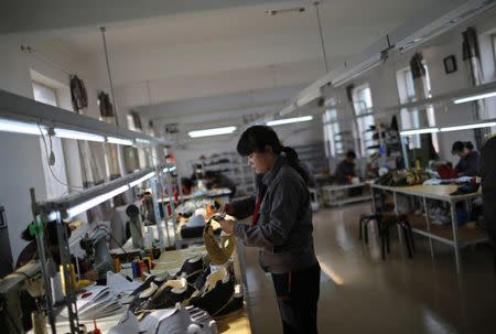File photo: North Korean workers make soccer shoes inside a temporary factory at a rural village on the edge of Dandong October 24, 2012. REUTERS/Aly Song