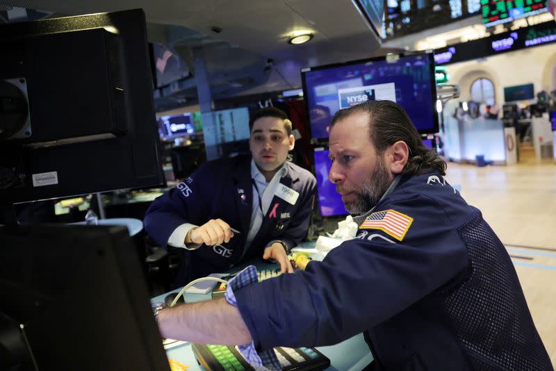 Traders work on the trading floor at the New York Stock Exchange (NYSE) in New York City