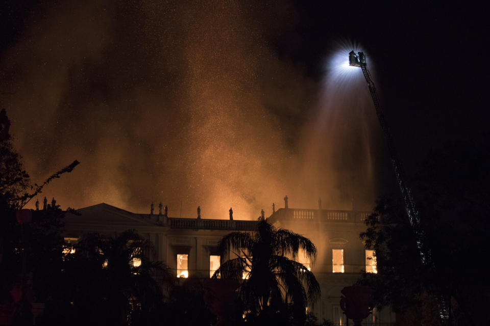 Firefighters work to douse the flames at the 200-year-old National Museum of Brazil, in Rio de Janeiro, Brazil, Sunday, Sept. 2, 2018. According to its website, the museum has thousands of items related to the history of Brazil and other countries. The museum is part of the Federal University of Rio de Janeiro. (AP Photo/Leo Correa)