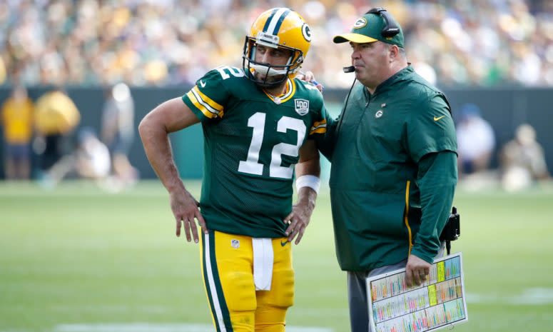 Green bay packers quarterback Aaron Rodgers speaking with Mike McCarthy.