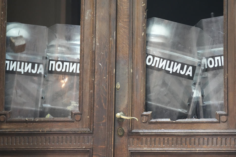 The entrance of city council building is secured by anti-riot police in Belgrade, Serbia, Sunday, Dec. 24, 2023. Police in Serbia have fired tear gas to prevent hundreds of opposition supporters from entering the capital's city council building to protest what election observers said were widespread vote irregularities during a general election a week ago. (AP Photo/Darko Vojinovic)