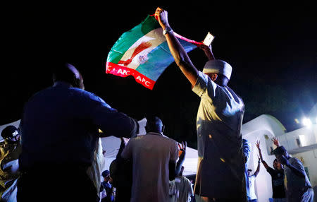 Supporters of Nigeria's President Muhammadu Buhari celebrate at the campaign headquarters of the All Progressives Congress (APC) party in Abuja, Nigeria February 26, 2019. REUTERS/Nneka Chile