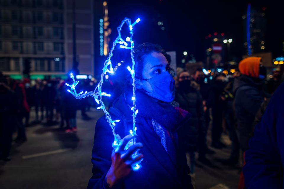 A demonstrator holds wire hanger, symbolizing illegal abortions, as she takes part in a protest for abortion rights in Warsaw, Poland, January 27, 2021. / Credit: WOJTEK RADWANSKI/AFP/Getty