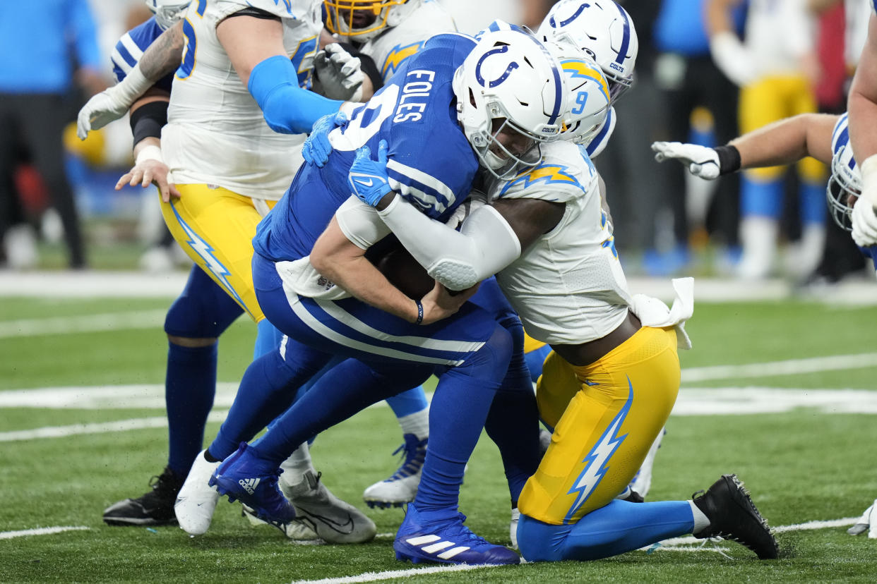 Indianapolis Colts quarterback Nick Foles (9) is sacked by Los Angeles Chargers' Kenneth Murray Jr. (9). (AP Photo/AJ Mast)