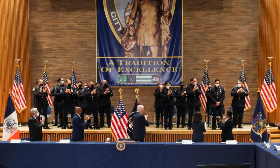 Joe Biden, attorney general Merrick Garland, Mayor Eric Adams and New York’s Governor Kathy Hochul applaud a police officer during a meeting about gun violence.