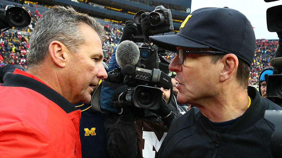 Ohio State’s Urban Meyer (L) has had the upper hand on Jim Harbaugh and Michigan since his arrival as head coach. (AP)