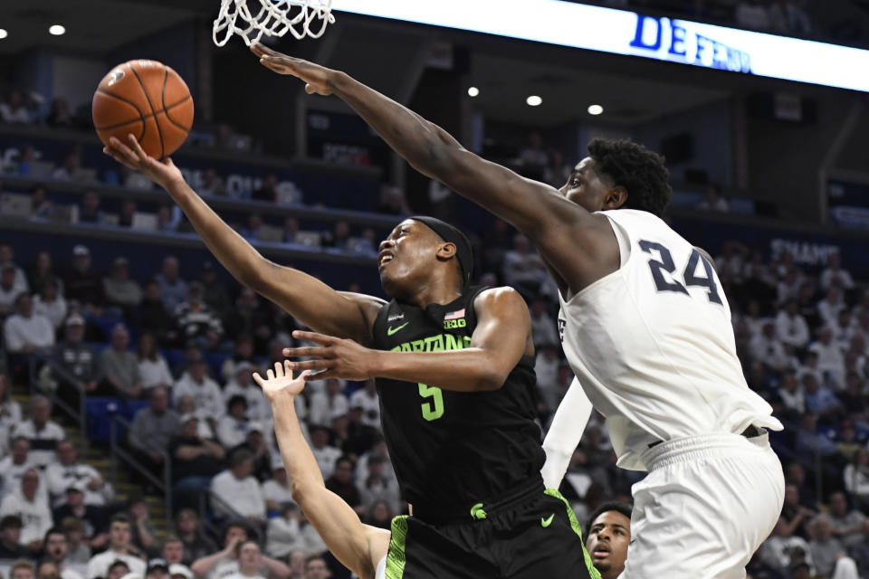 Michigan State's Cassius Winston (5) shoots as Penn State's Mike Watkins (24) defends during the first half of an NCAA college basketball game Tuesday, March 3, 2020, in State College, Pa. (AP Photo/John Beale)