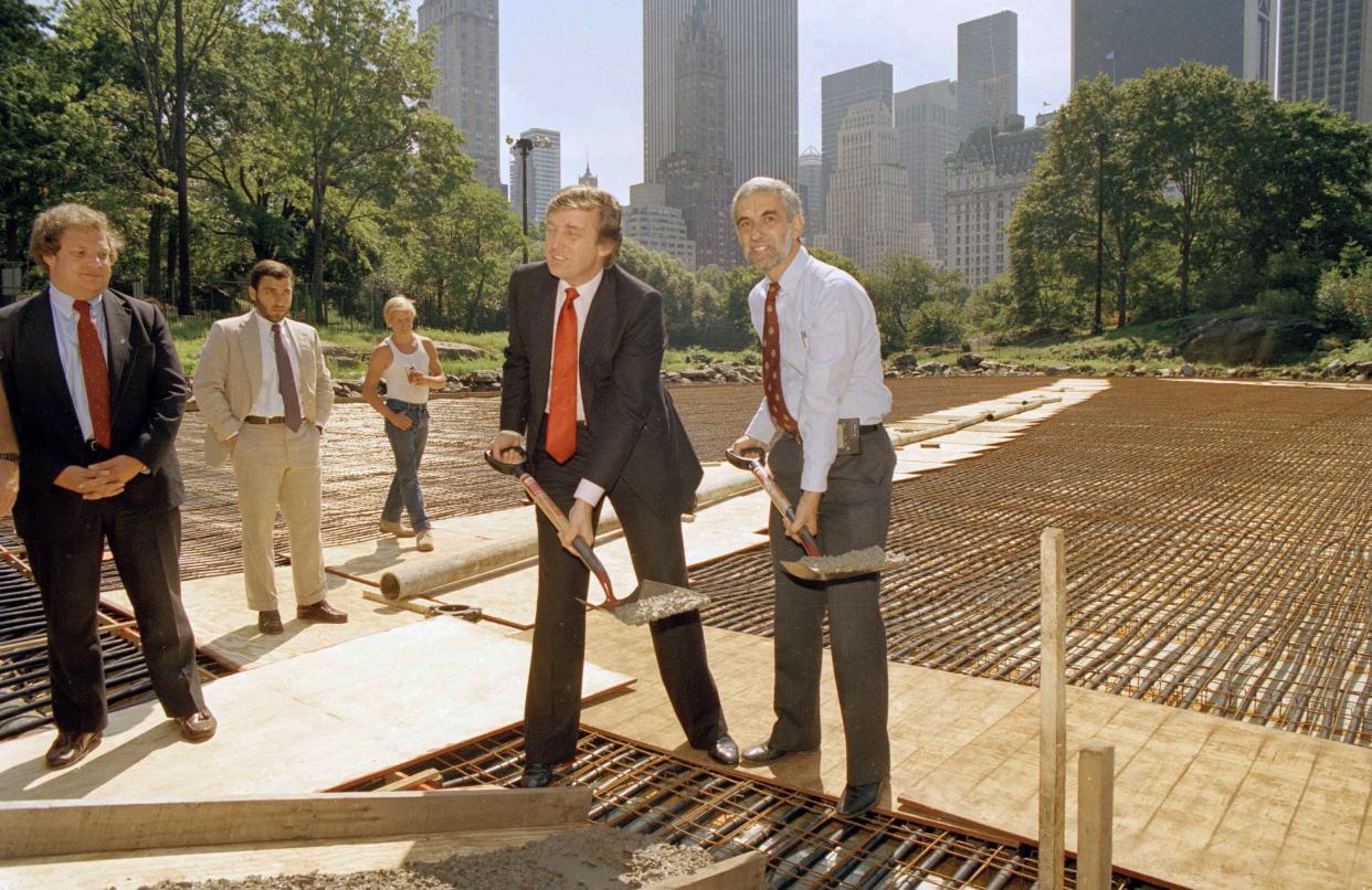 New York City Parks Commissioner Henry Stern, right, and real estate mogul Donald Trump, lift shovels of cement to mark the start of concrete pouring in Central Park's Wollman Rink, on Sept. 10, 1986. Trump is financing the rebuilding of the rink.