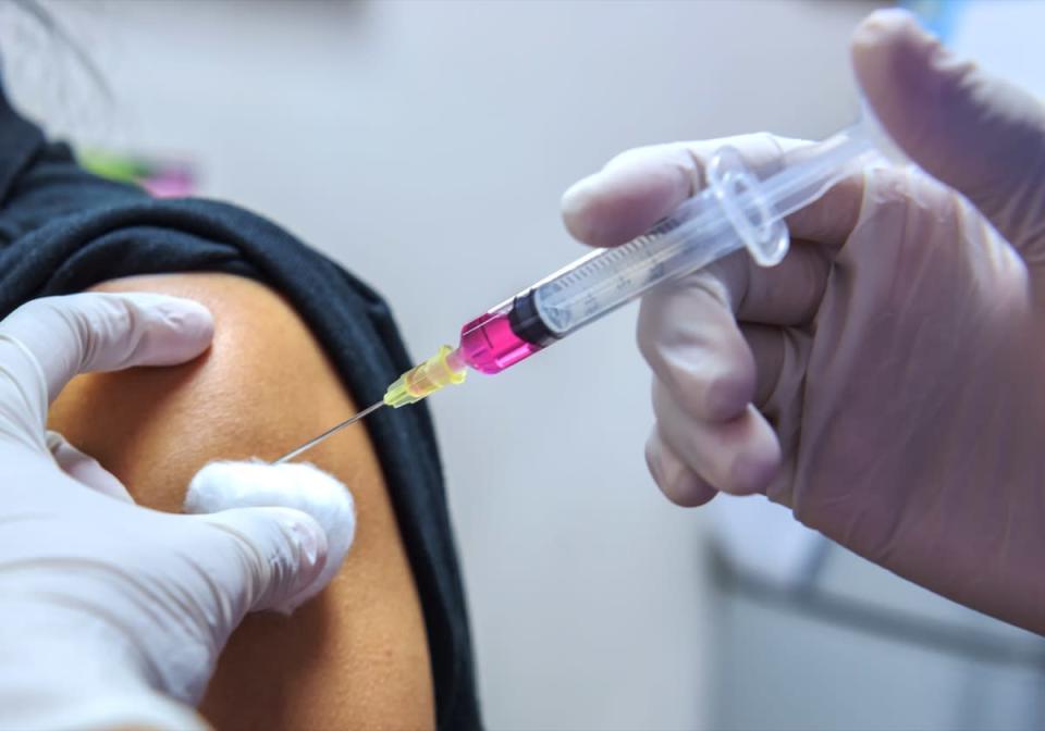 Doctor vaccinating women in hospital