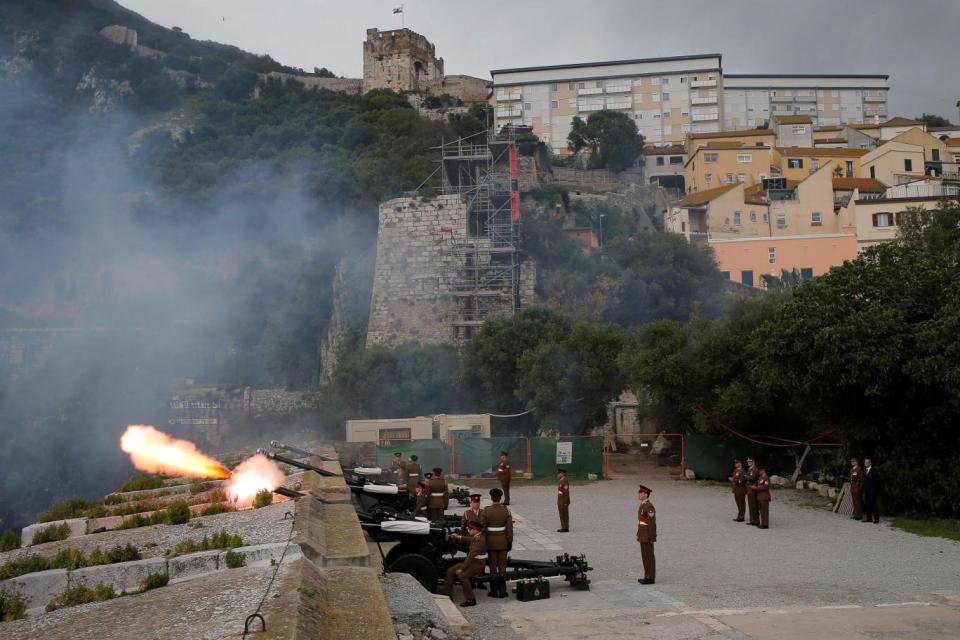 Members of the Royal Gibraltar Regiment fire a 21-gun salute in the British overseas territory (REUTERS)