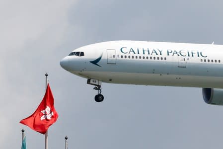 FILE PHOTO: A Cathay Pacific Boeing 777 plane lands at Hong Kong airport after it reopened following clashes between police and protesters