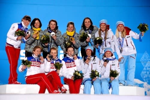 Silver medalists Russia, gold medalists Ukraine and bronze medalists Norway celebrate during the medal ceremony for the Biathlon Women's 4 x 6 km Relay
