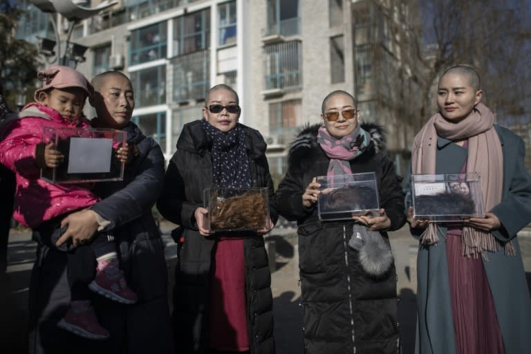 Yuan Shanshan, left, Liu Ermin, Wang Qiaoling and Li Wenzu pose shaved their heads to protest the detention of their husbands, detained during the so-caled 709 crackdown