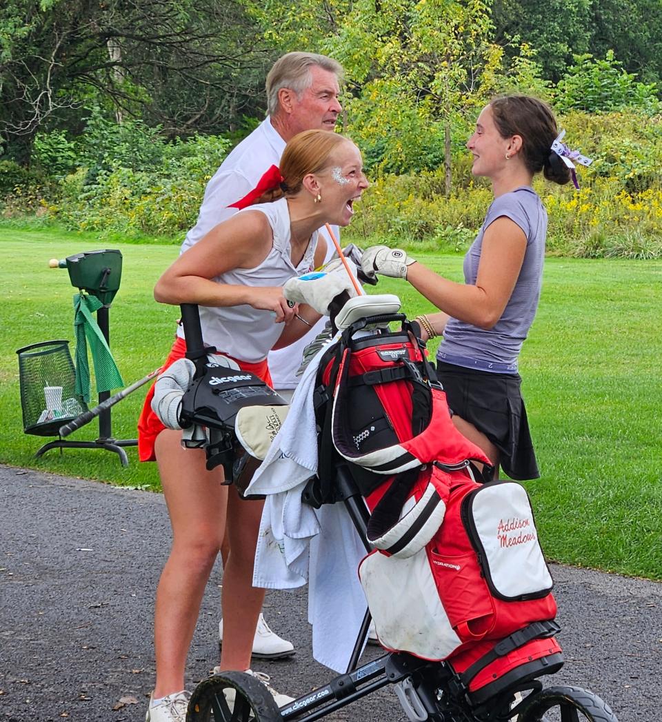 Southmont senior Addison Meadows (left) unleashes a jaw opening laugh with Maddie Campbell of Brownsburg (right) with Southmont coach Dave Williamson (center) in the background during the IHSAA regional championship at Battle Ground Golf Club on Saturday, Sept. 28, 2024 in Battle Ground, Ind.