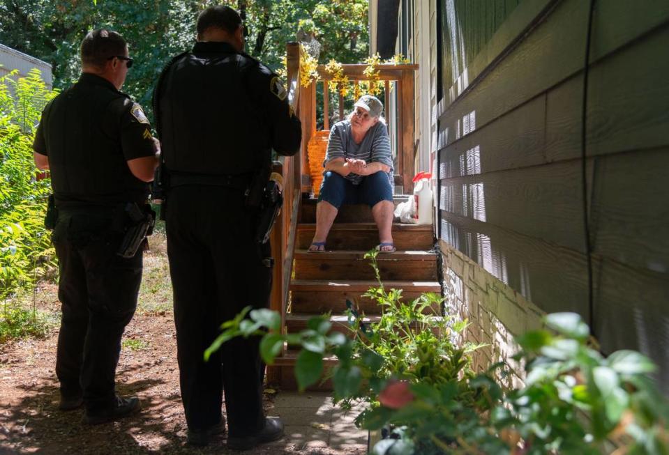 Sacramento County deputies speak with Hope Messatzzia at her mobile home in Forest Ranch on Friday, July 26, 2024. The officers offered to assist Messatzzia, but she told them she was choosing to stay in her home for the time being despite having no gas in her car and no electricity.