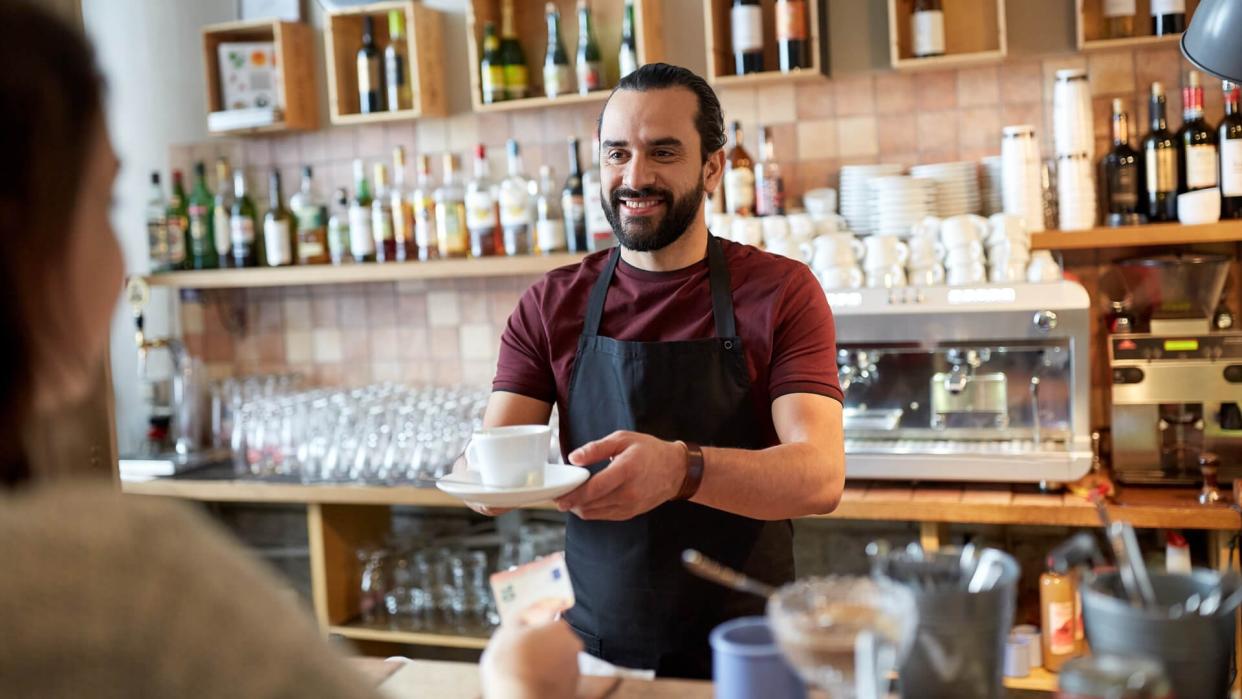 male barista serving coffee
