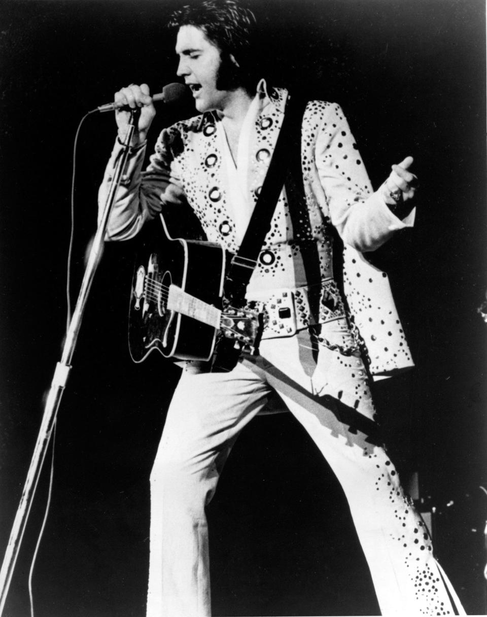 Elvis Presley is shown performing in this undated photo at an unknown location. Nutballz, a cookie company founded by a snowboarder, says it has won an eBay auction to borrow a plastic foam cup its owner says was used by Elvis Presley during a 1977 concert. (AP Photo/File)