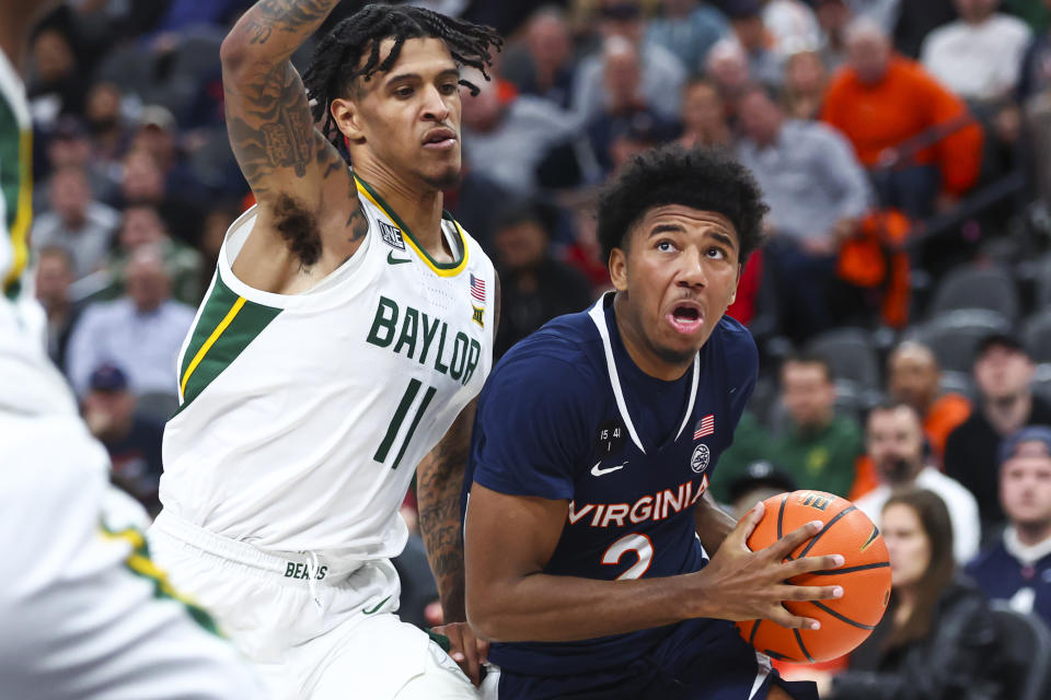 Virginia guard Reece Beekman (2) drives to the basket against Baylor forward Jalen Bridges (11) during the first half of an NCAA college basketball game Friday, Nov. 18, 2022, in Las Vegas. (AP Photo/Chase Stevens)