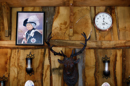 An oil painting of the Queen Elizabeth is pictured in "Robin Hood's hut" at the British curiosities collection "Little Britain" of Gary Blackburn, a 53-year-old tree surgeon from Lincolnshire, Britain, in Linz-Kretzhaus, south of Germany's former capital Bonn, Germany, August 24, 2017. REUTERS/Wolfgang Rattay