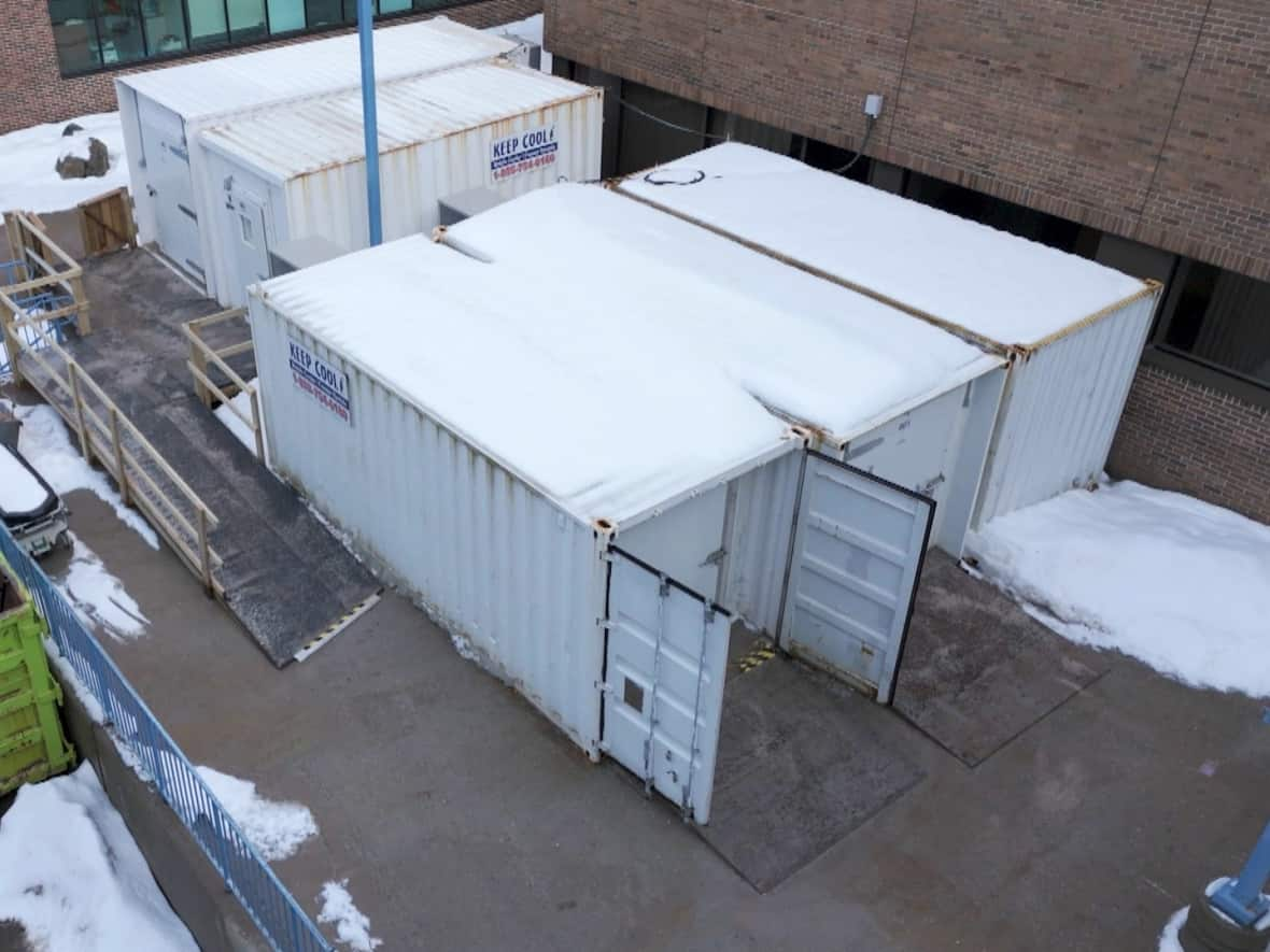 These freezer containers, holding about 28 bodies at last count, sit in an alley between the Janeway children's hospital and Memorial University's school of medicine.  (Danny Arsenault/CBC - image credit)