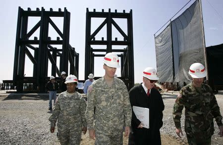 Maj. Gen. Don Riley (2nd L), Director of Civil Works for the U.S. Army Corps of Engineers, speaks with Jefferson Parish President Aaron Broussard (2nd R) at the fabrication site of the 17th Street Canal interim gated structure in New Orleans in this March 23, 2006 file photo. REUTERS/Lee Celano/Files